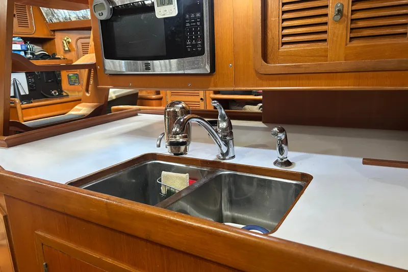  Yacht Photos Pics Galley kitchen in 1995 Tayana 48 yacht with sink and microwave.