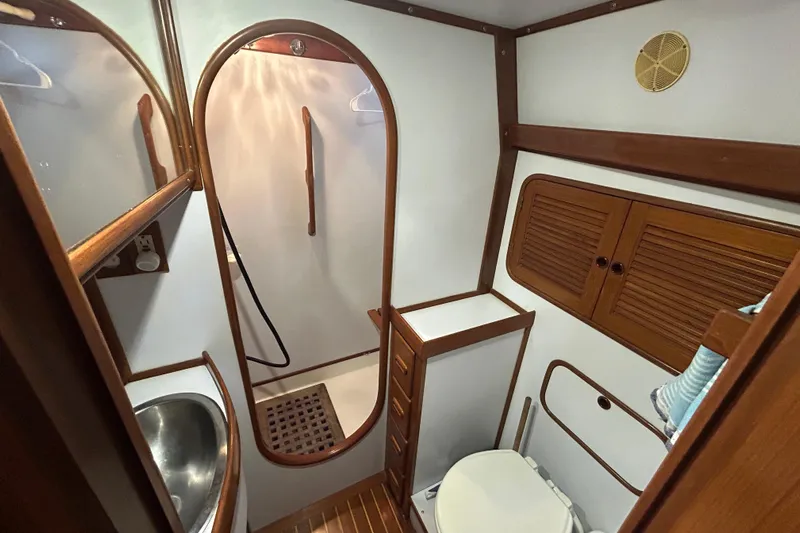  Yacht Photos Pics Bathroom interior of 1995 Tayana 48 yacht with wooden accents and compact design.