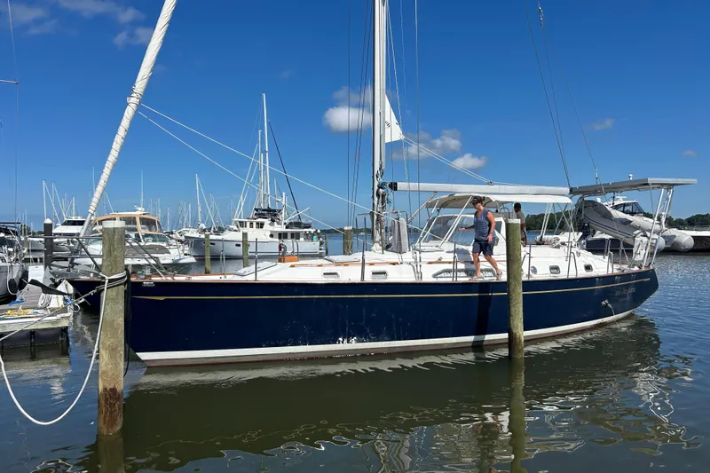  Yacht Photos Pics 1995 Tayana 48 sailboat docked at marina under clear blue sky.
