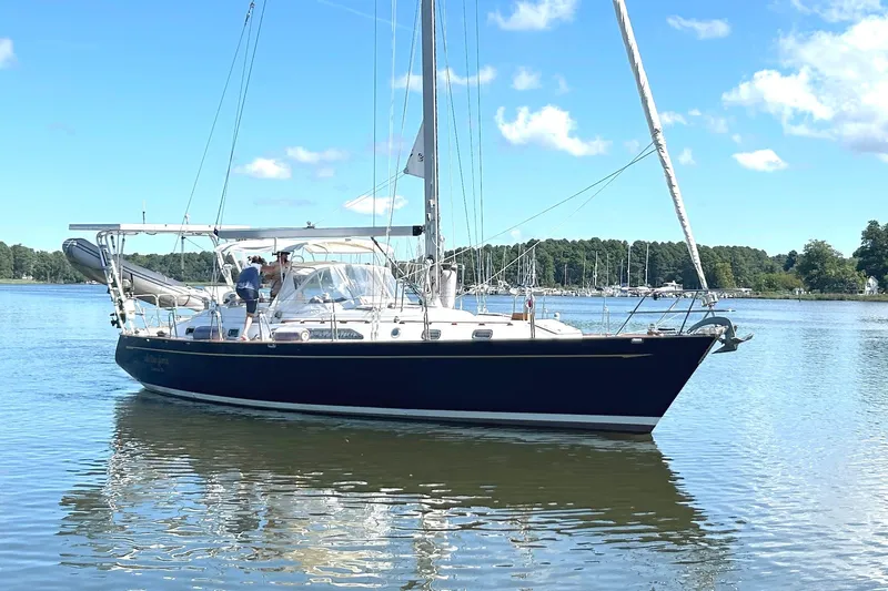  Yacht Photos Pics Sailing yacht Tayana 48, 1995 model, on calm waters under a clear blue sky.