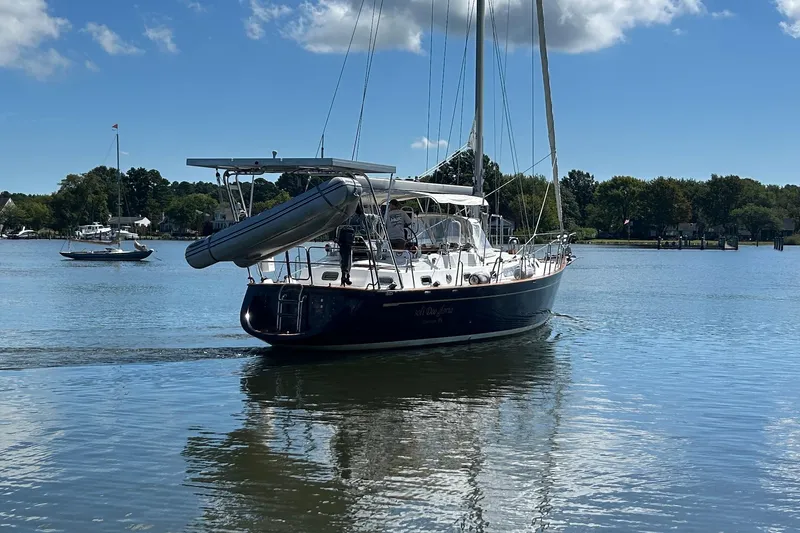 Yacht Photos Pics Sailing yacht Tayana 48, 1995 model, cruising on a calm lake under a clear blue sky.
