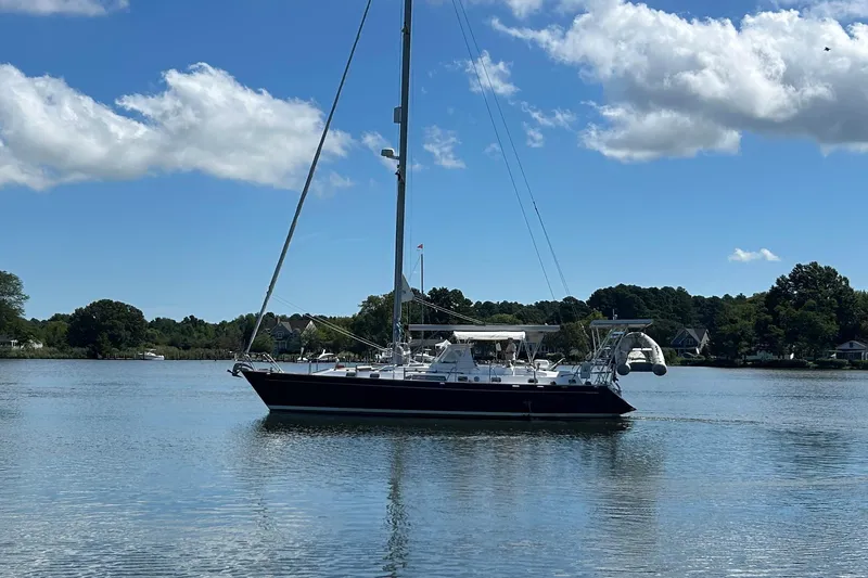  Yacht Photos Pics Sailboat Tayana 48, 1995 model, on calm water under a clear blue sky.