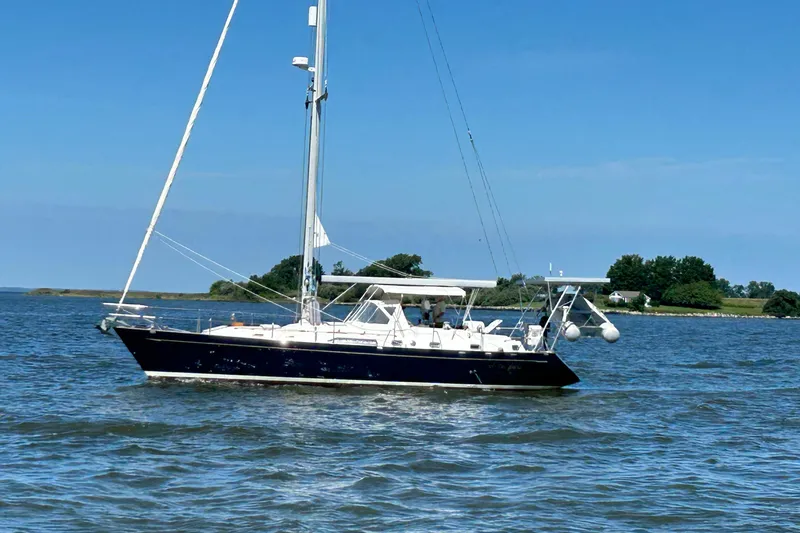  Yacht Photos Pics Sailing yacht Tayana 48, 1995 model, cruising on a calm sea with clear skies.