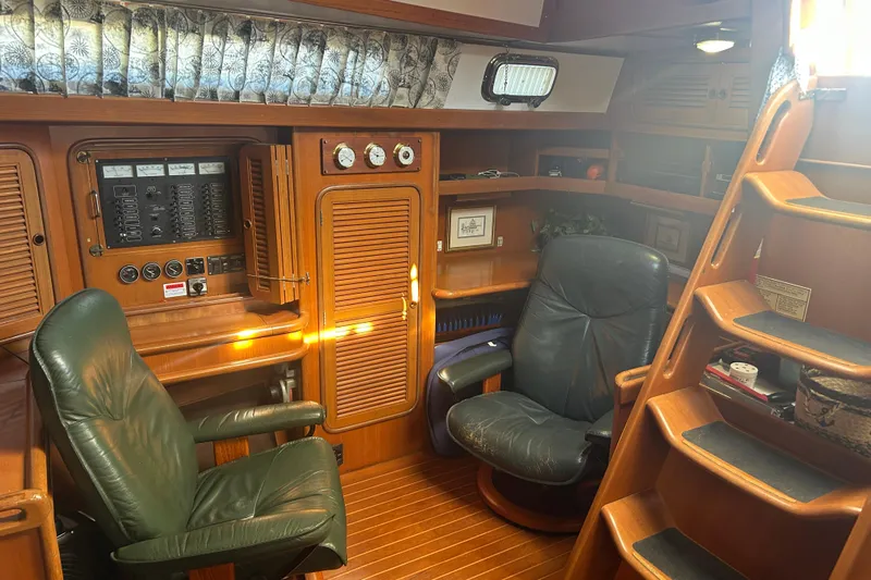  Yacht Photos Pics Interior of 1995 Tayana 48 yacht with leather chairs and wooden cabinetry.