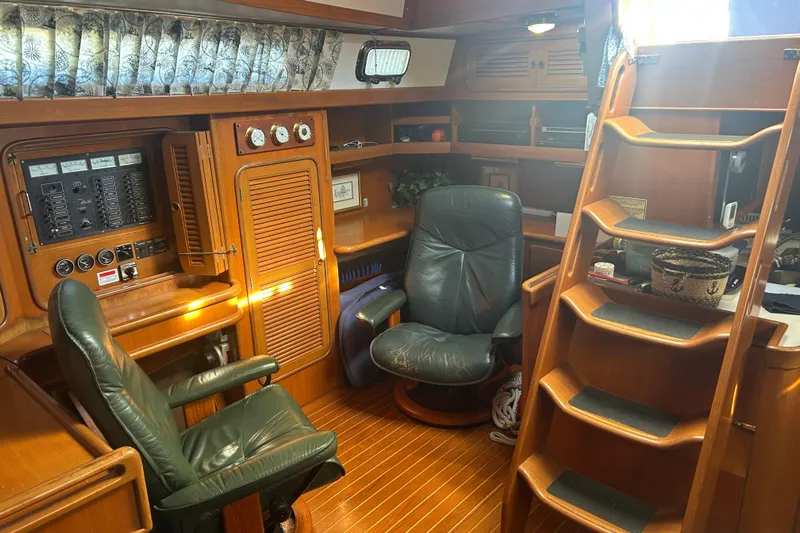  Yacht Photos Pics Interior of 1995 Tayana 48 yacht with wooden furnishings and leather chairs.