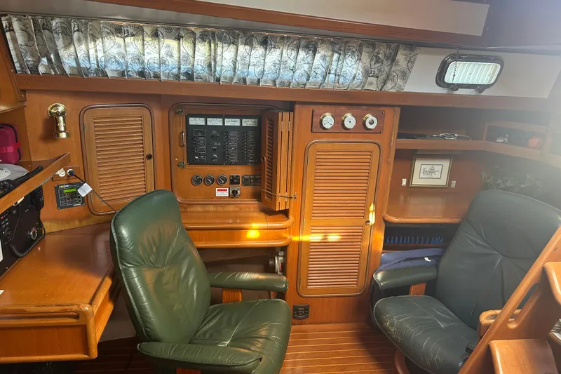 Yacht Photos Pics Interior of 1995 Tayana 48 yacht with wooden cabinetry and leather chairs.