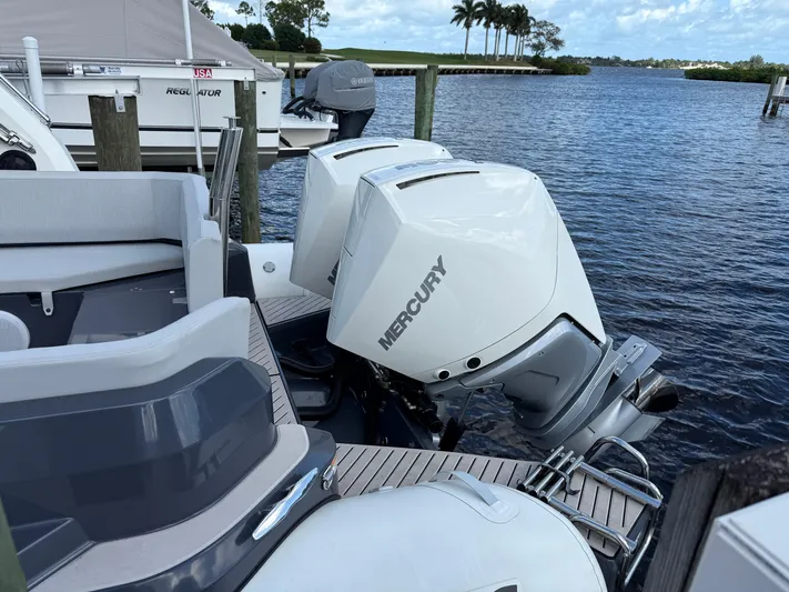  Yacht Photos Pics 2024 Zodiac Medline 9 boat with Mercury outboard engines docked by the water.