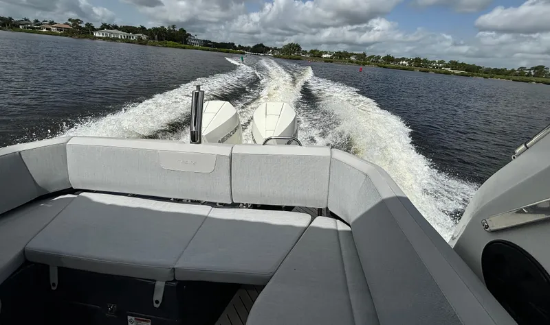  Yacht Photos Pics 2024 Zodiac Medline 9 cruising on a lake, showcasing rear seating and powerful wake.