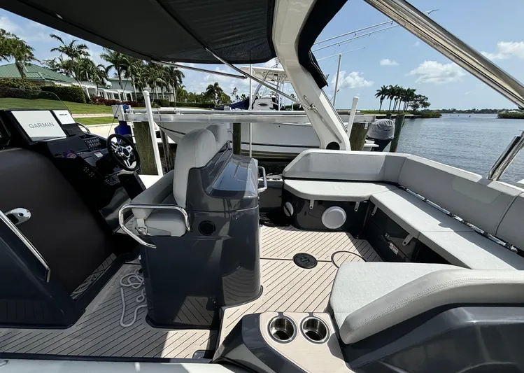  Yacht Photos Pics 2024 Zodiac Medline 9 boat interior with seating, steering console, and waterfront view.
