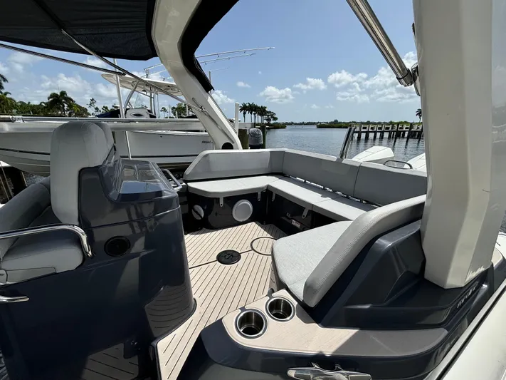  Yacht Photos Pics 2024 Zodiac Medline 9 boat interior with sleek seating and modern design, docked by the water.