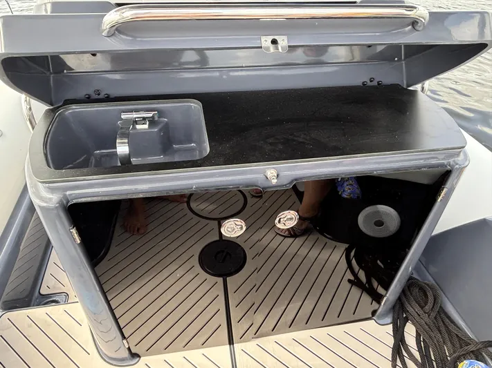  Yacht Photos Pics 2024 Zodiac Medline 9 boat interior with open storage compartment and sink.