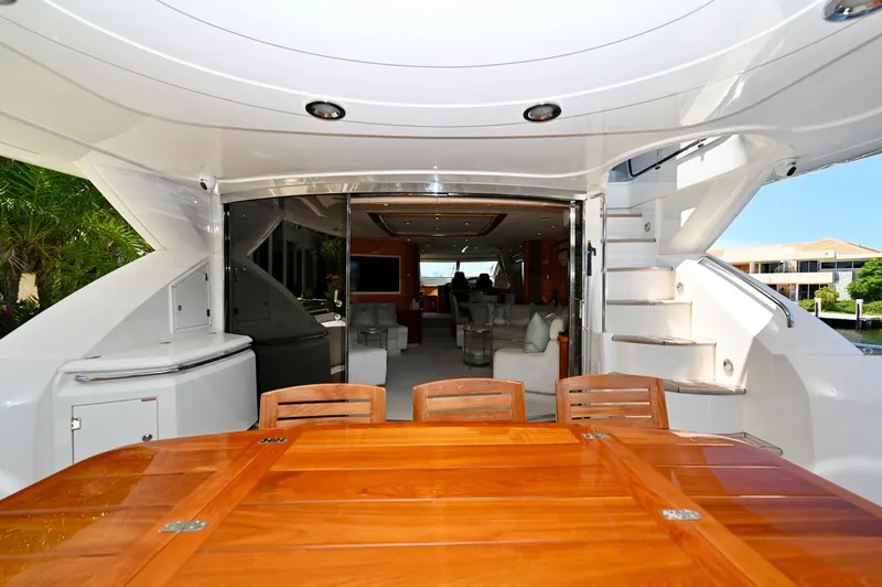 "bella" Yacht Photos Pics Luxurious 2005 Sunseeker 82 Yacht interior with elegant wooden dining table and spacious seating area.