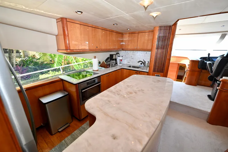 "bella" Yacht Photos Pics Luxurious kitchen interior of 2005 Sunseeker 82 Yacht with marble countertops and modern appliances.