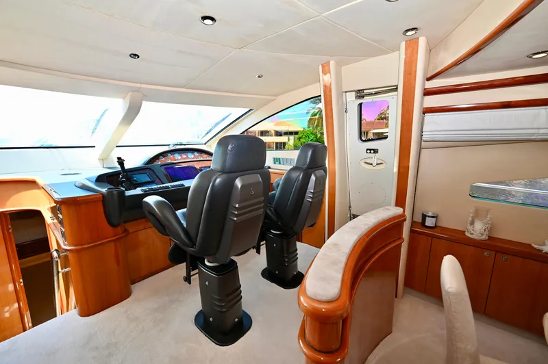 "bella" Yacht Photos Pics Interior view of 2005 Sunseeker 82 Yacht cockpit with luxurious seating and control panel.