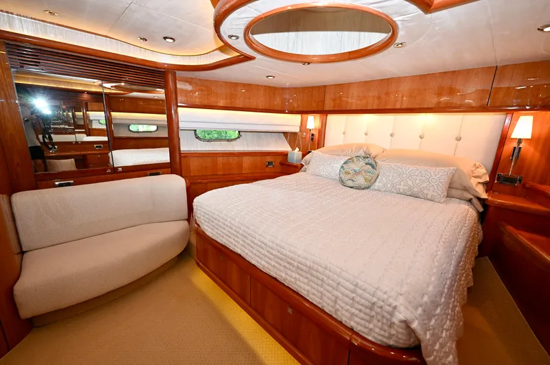 "bella" Yacht Photos Pics Luxurious bedroom interior of a 2005 Sunseeker 82 Yacht with elegant wood finishes.