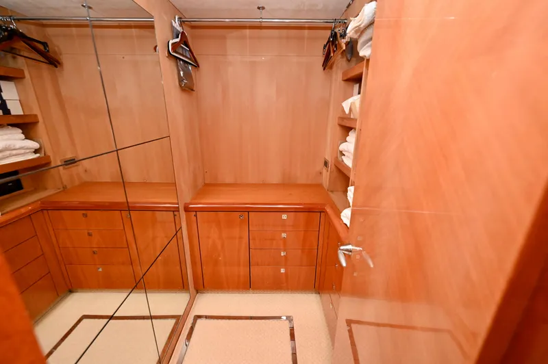 "bella" Yacht Photos Pics Luxurious wooden closet interior on a 2005 Sunseeker 82 Yacht, featuring ample storage and mirrors.