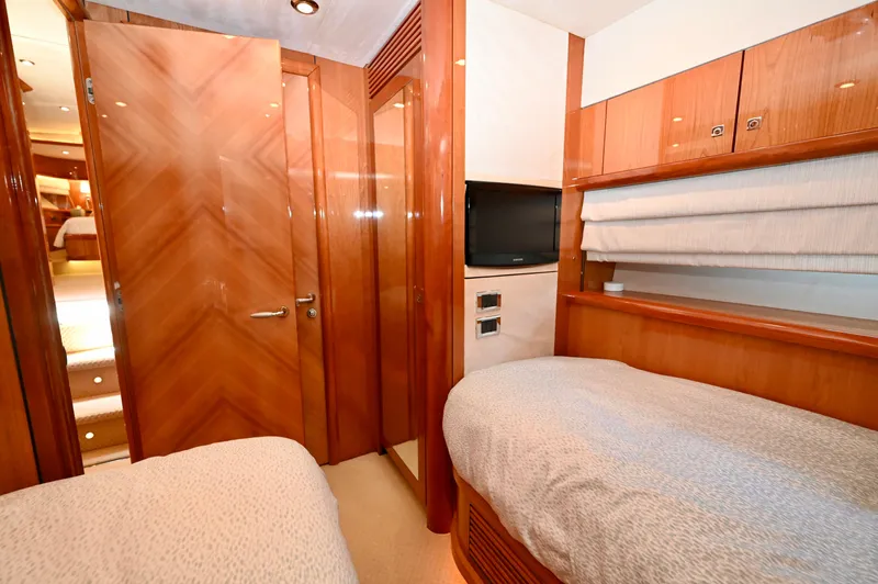 "bella" Yacht Photos Pics Luxurious cabin interior of 2005 Sunseeker 82 Yacht with twin beds and wood finish.