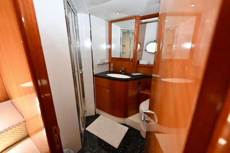 "bella" Yacht Photos Pics Luxurious bathroom on a 2005 Sunseeker 82 Yacht with modern fixtures and wood accents.