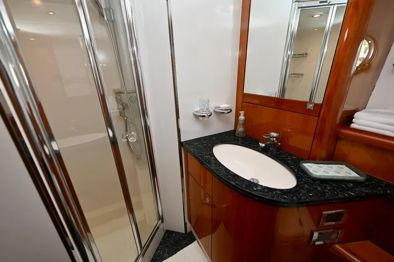 "bella" Yacht Photos Pics Luxurious bathroom in a 2005 Sunseeker 82 Yacht, featuring elegant wood and chrome finishes.