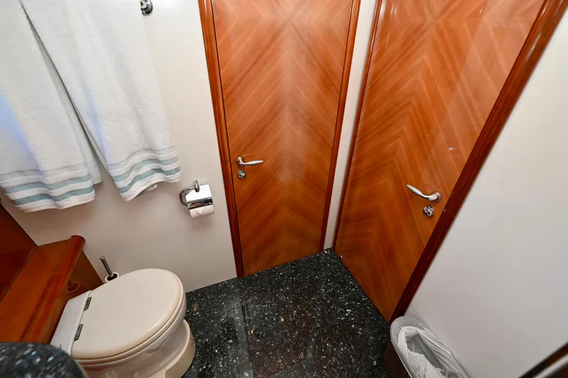"bella" Yacht Photos Pics Luxurious bathroom on a 2005 Sunseeker 82 Yacht with elegant wood doors and marble flooring.