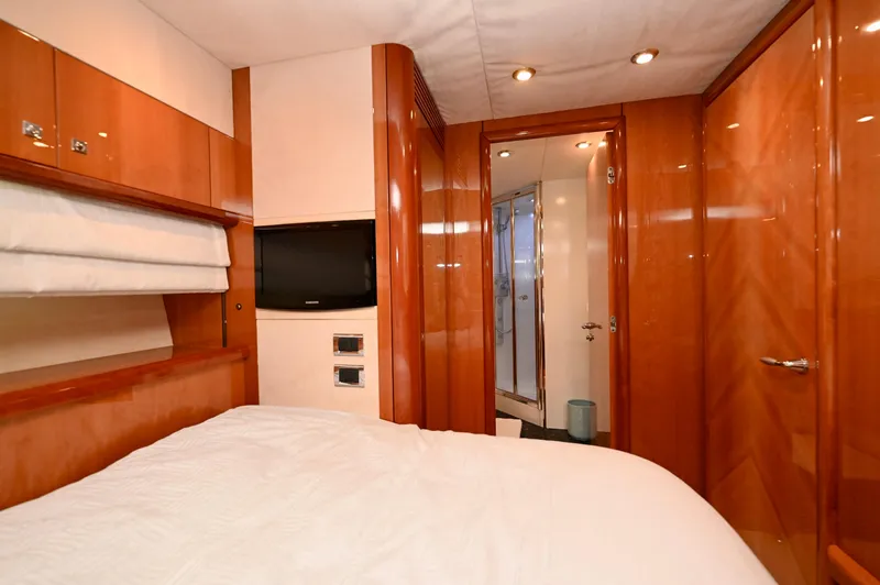 "bella" Yacht Photos Pics Luxurious cabin interior of 2005 Sunseeker 82 Yacht with wood paneling and modern amenities.