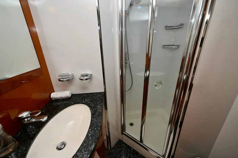 "bella" Yacht Photos Pics Luxurious bathroom on 2005 Sunseeker 82 Yacht with sleek shower and elegant sink.