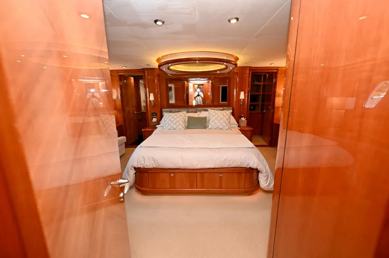"bella" Yacht Photos Pics Luxurious bedroom interior of a 2005 Sunseeker 82 Yacht with elegant wood finishes.