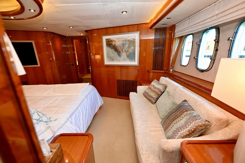 "bella" Yacht Photos Pics Luxurious interior of 2005 Sunseeker 82 Yacht with elegant wood paneling and cozy seating.
