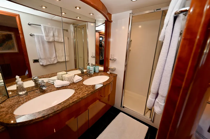 "bella" Yacht Photos Pics Luxurious bathroom in a 2005 Sunseeker 82 Yacht with dual sinks and elegant finishes.