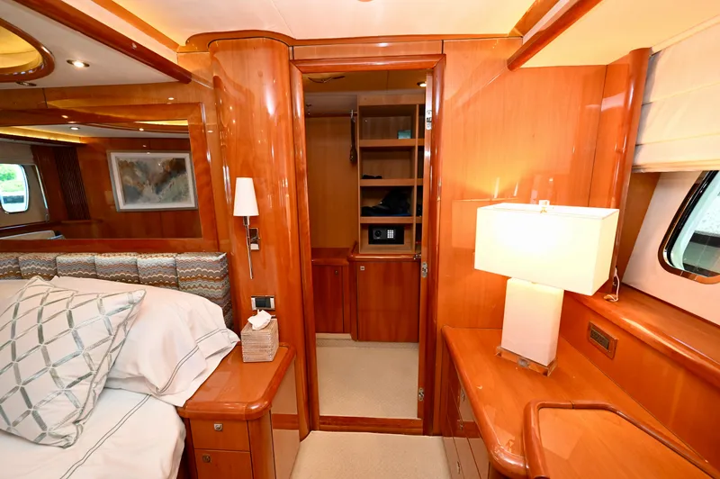 "bella" Yacht Photos Pics Luxurious interior of 2005 Sunseeker 82 Yacht with elegant wood finish and cozy bedroom.