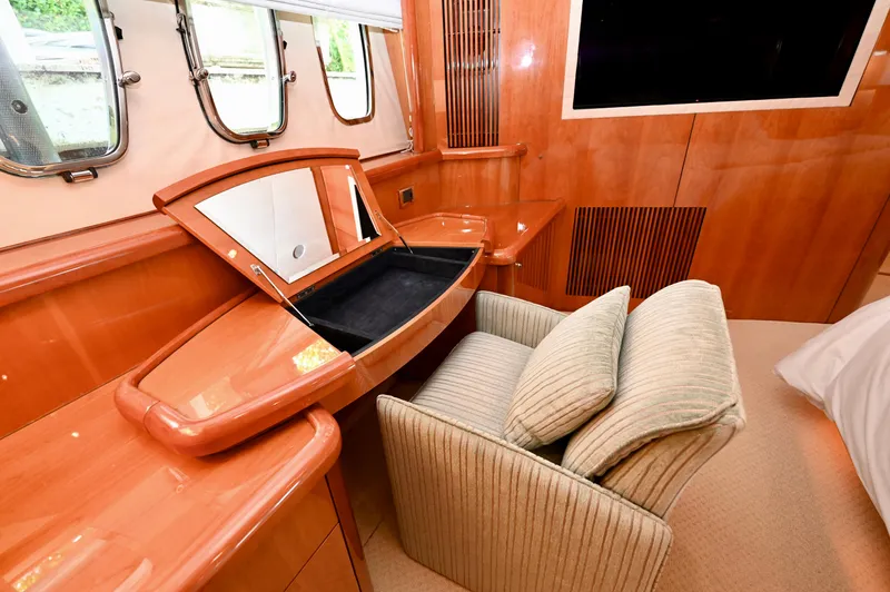 "bella" Yacht Photos Pics Luxurious interior of 2005 Sunseeker 82 Yacht with elegant wood finish and vanity area.