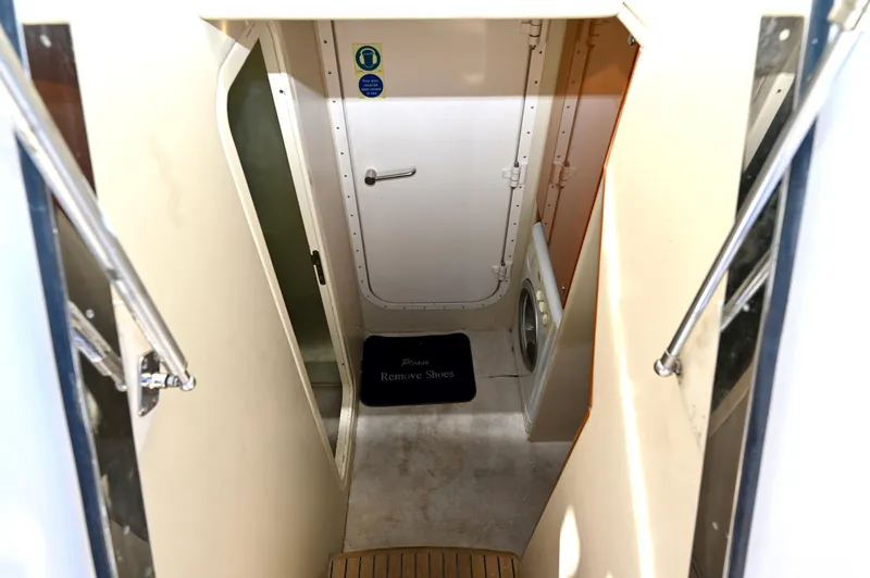 "bella" Yacht Photos Pics Interior view of 2005 Sunseeker 82 Yacht, featuring a narrow passageway and door.