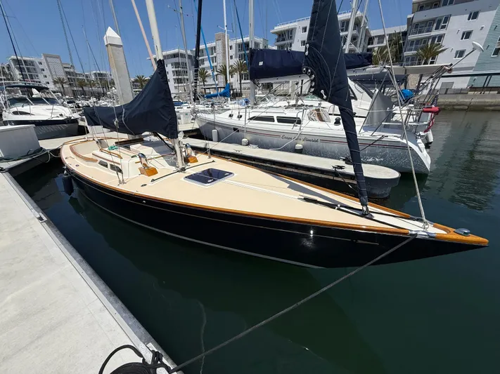 Bolero Yacht Photos Pics Sleek 2012 Morris M29 sailboat docked in marina, surrounded by other vessels.