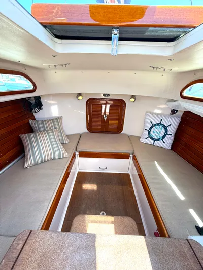Bolero Yacht Photos Pics Interior of 2012 Morris M29 sailboat with cozy seating and nautical-themed decor.