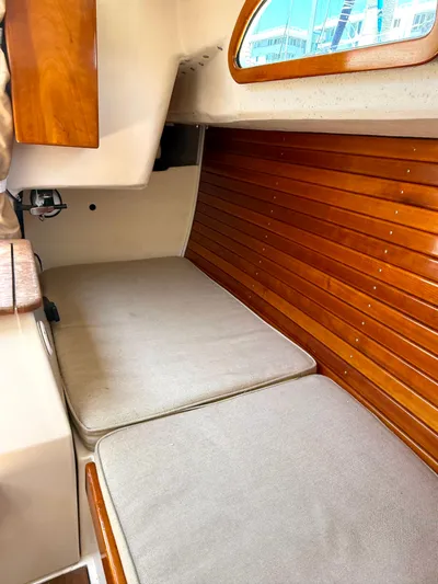 Bolero Yacht Photos Pics Interior of a 2012 Morris M29 boat with wooden paneling and cushioned seating.