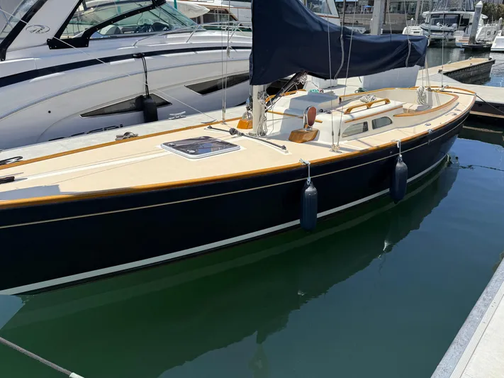 Bolero Yacht Photos Pics Sleek 2012 Morris M29 sailboat docked in marina, featuring elegant design and blue hull.