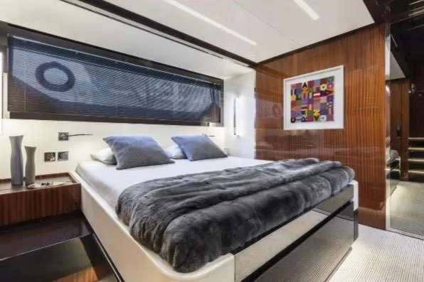  Yacht Photos Pics Luxurious bedroom interior of 2024 Riva 56 Rivale yacht with modern decor and plush bedding.