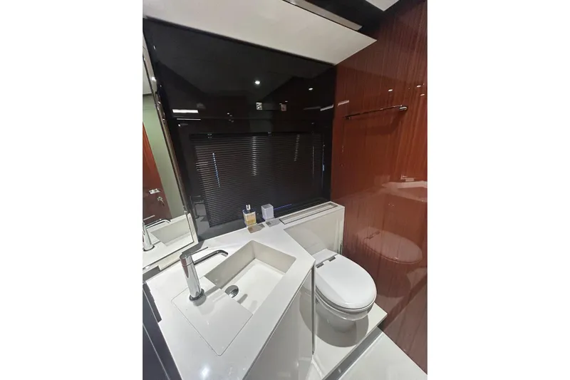  Yacht Photos Pics Luxurious bathroom interior of 2024 Riva 56 Rivale yacht, featuring modern sink and toilet.