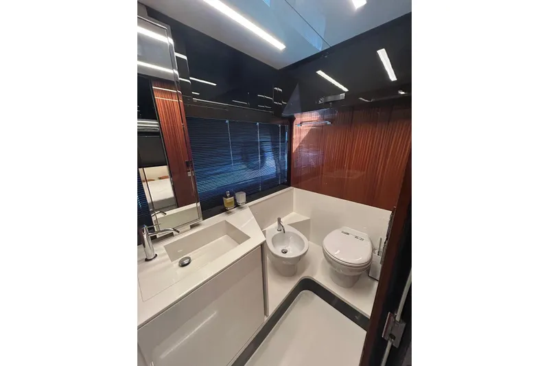  Yacht Photos Pics Luxurious bathroom in 2024 Riva 56 Rivale yacht with modern fixtures and sleek design.