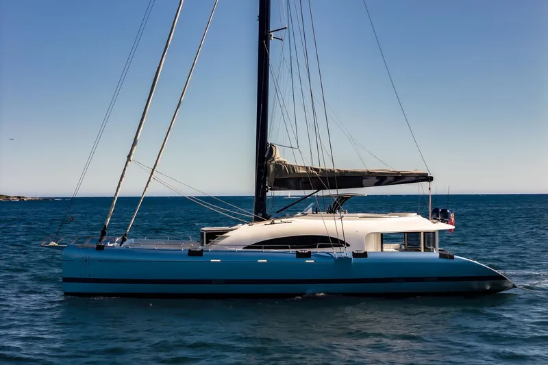 Lyfe At Sea Yacht Photos Pics Sleek 2015 Magic Yachts Custom sailing yacht on open sea under clear sky.