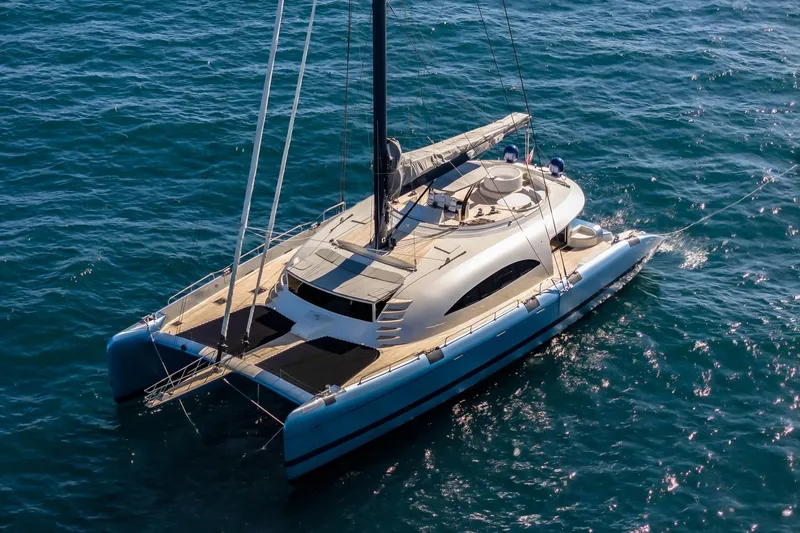 Lyfe At Sea Yacht Photos Pics Luxurious 2015 Magic Yachts Custom catamaran sailing on clear blue ocean waters.