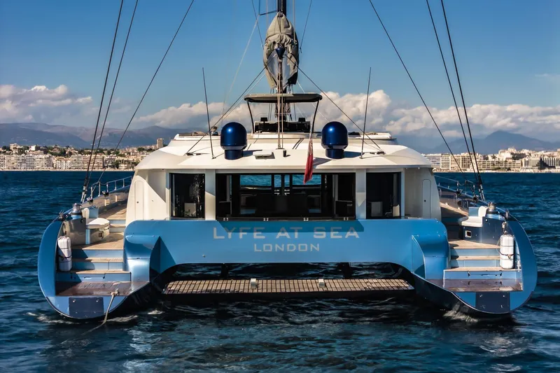Lyfe At Sea Yacht Photos Pics Luxury Magic Yachts Custom 2015 catamaran "Lyfe at Sea" on ocean, cityscape background.