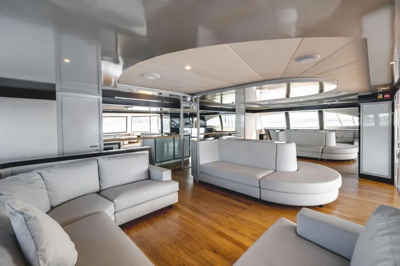 Lyfe At Sea Yacht Photos Pics Luxurious interior of 2015 Magic Yachts Custom model with modern seating and wooden flooring.