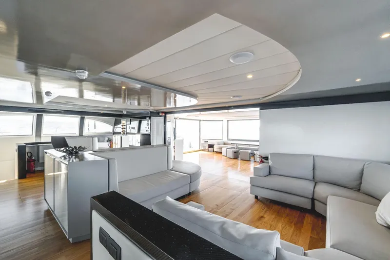 Lyfe At Sea Yacht Photos Pics Luxurious interior of 2015 Magic Yachts Custom model with modern seating and wooden flooring.