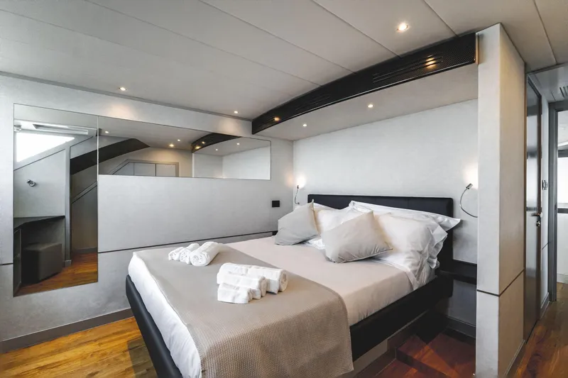 Lyfe At Sea Yacht Photos Pics Luxurious bedroom interior on 2015 Magic Yachts Custom model, featuring elegant design and cozy bedding.