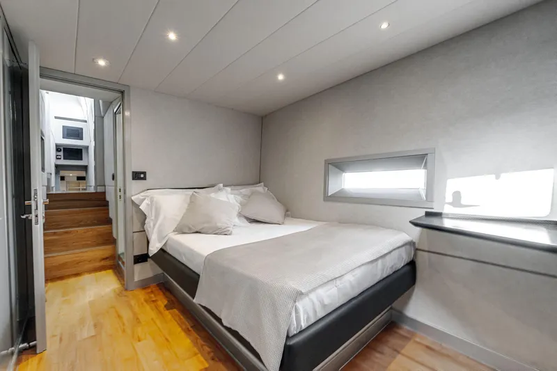Lyfe At Sea Yacht Photos Pics Luxurious bedroom interior on 2015 Magic Yachts Custom, featuring modern design and cozy ambiance.