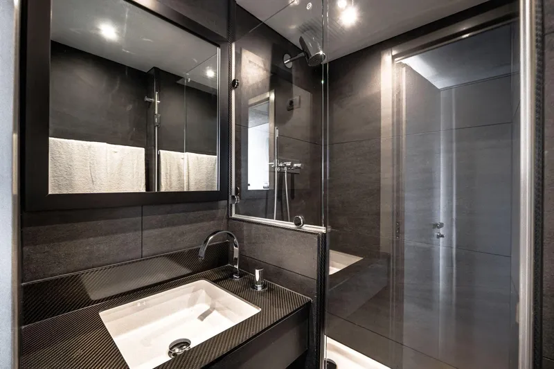 Lyfe At Sea Yacht Photos Pics Luxurious yacht bathroom with modern design, featuring sleek fixtures and dark finishes, Magic Yachts 2015.