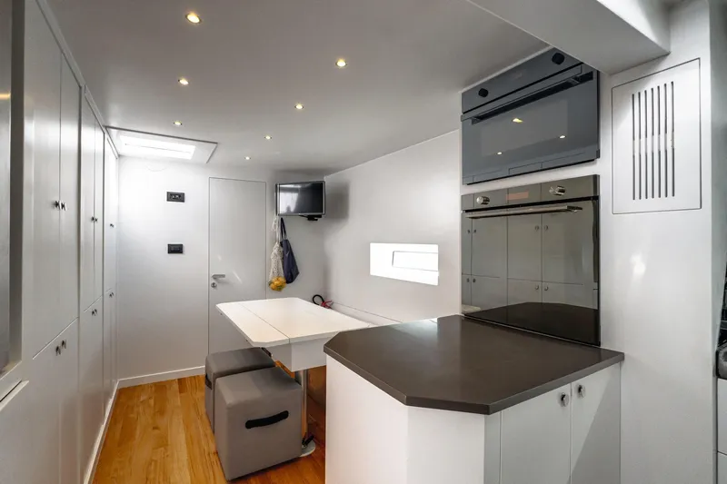 Lyfe At Sea Yacht Photos Pics Modern yacht interior with sleek kitchen and dining area, Magic Yachts Custom 2015 model.