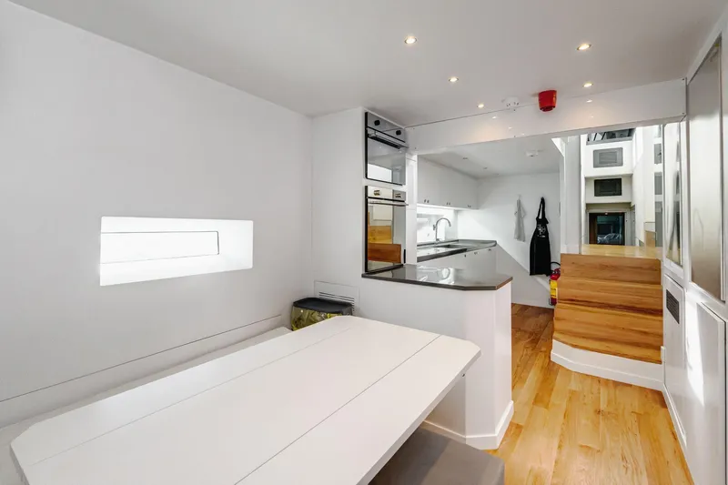 Lyfe At Sea Yacht Photos Pics Modern yacht interior with sleek kitchen and dining area, Magic Yachts Custom 2015 model.