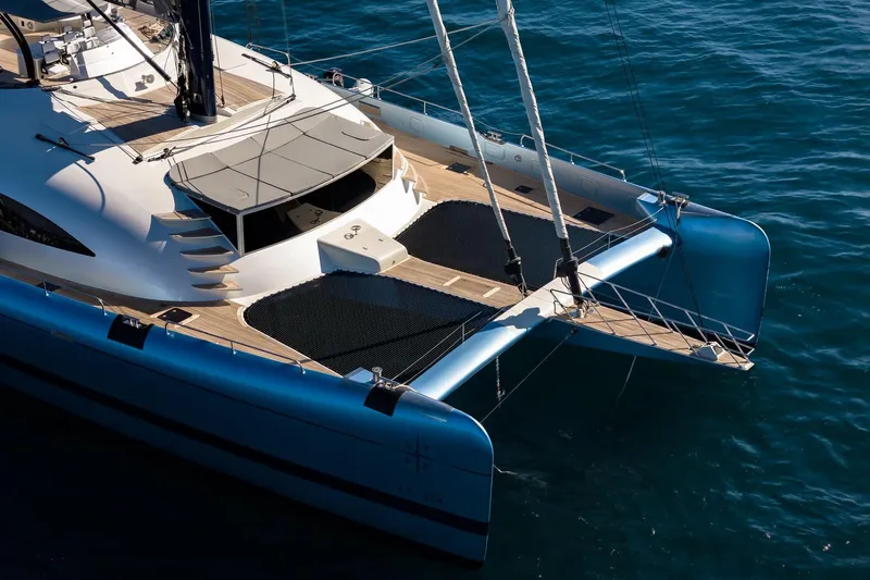 Lyfe At Sea Yacht Photos Pics Luxurious 2015 Magic Yachts Custom catamaran sailing on clear blue waters.